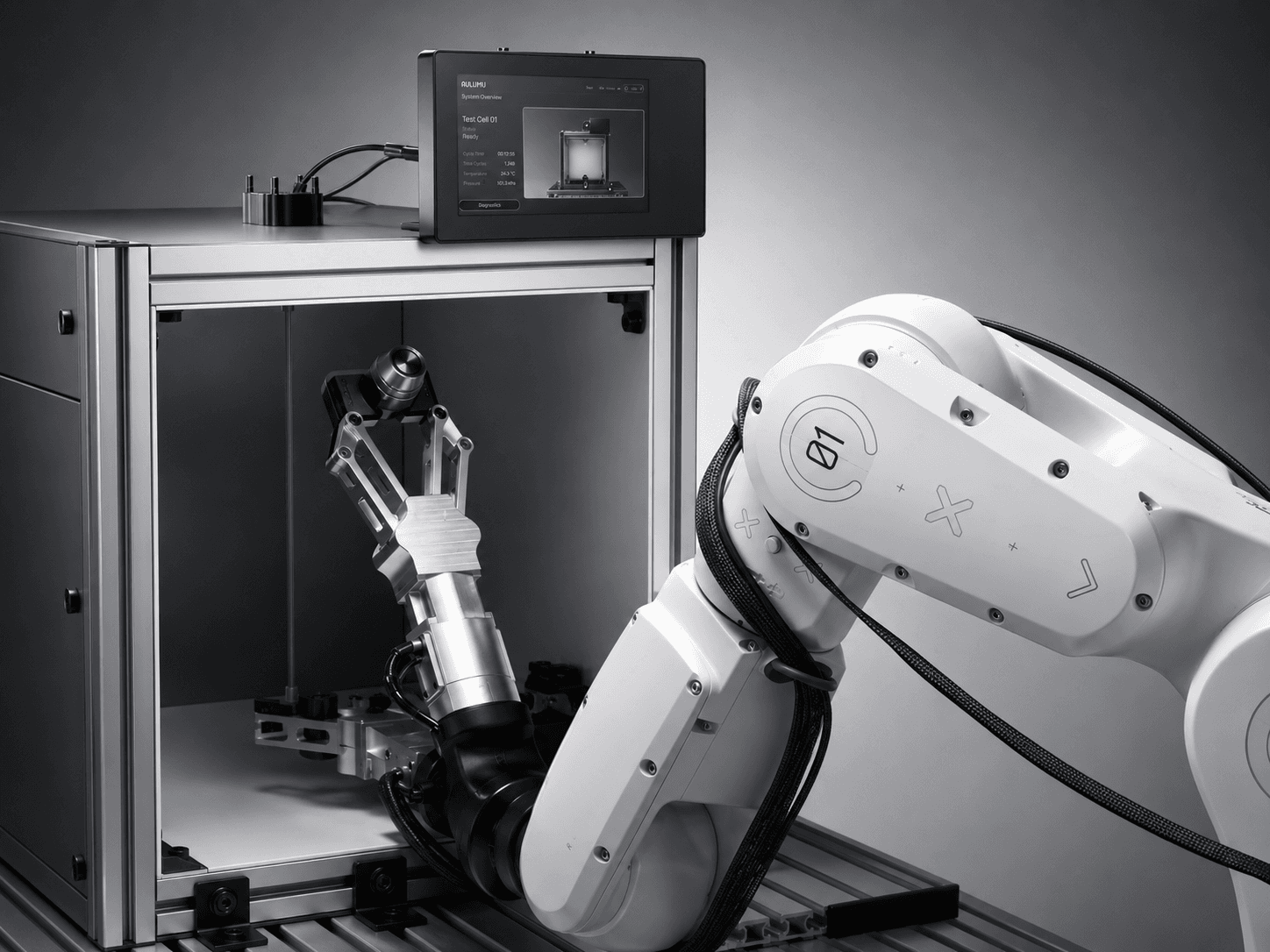 Autonomous CNC machining cell with a robotic arm loading a part